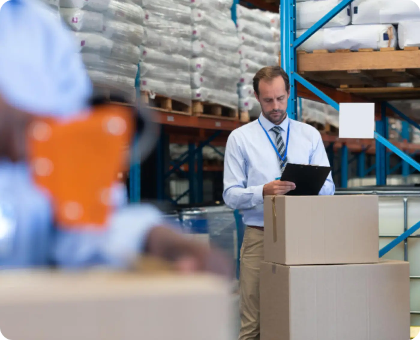 Warehouse staff checking stock against a clipboard