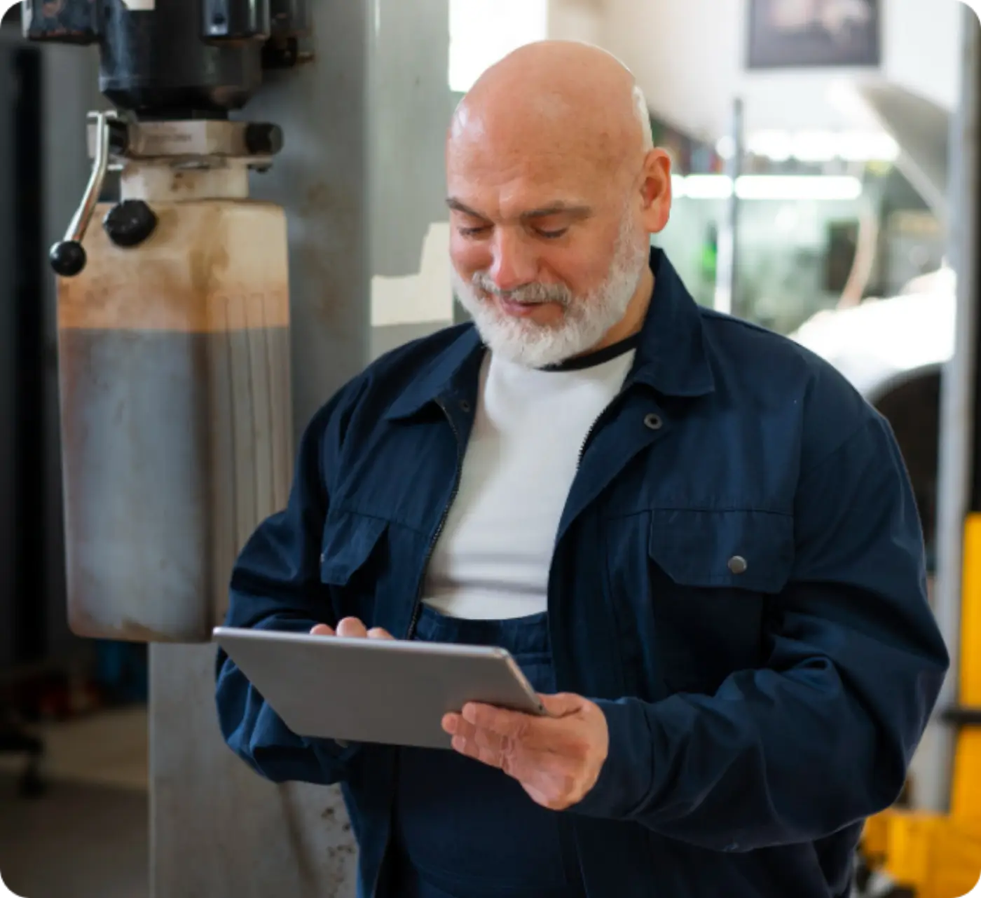 Machinist checking a job at a drill press