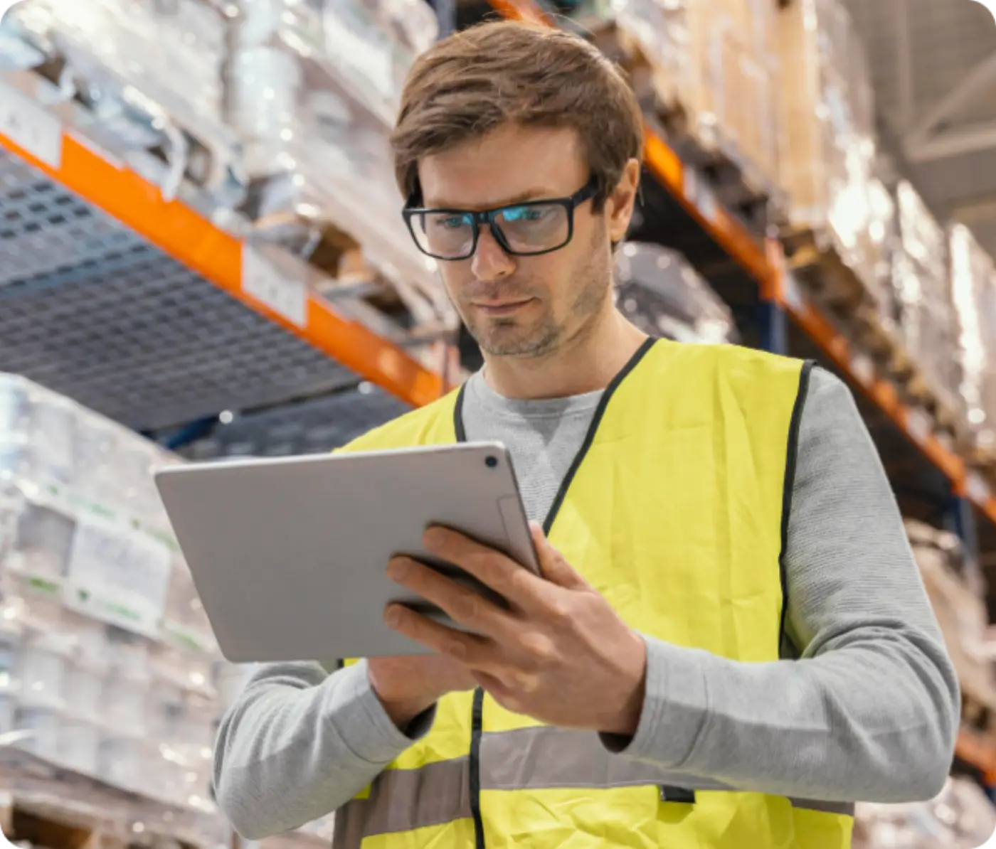 Warehouse worker scanning stock in a racking aisle